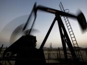 Associated Press files
An oil pump works at sunset in the desert oil fields of Sakhir, Bahrain, in October.