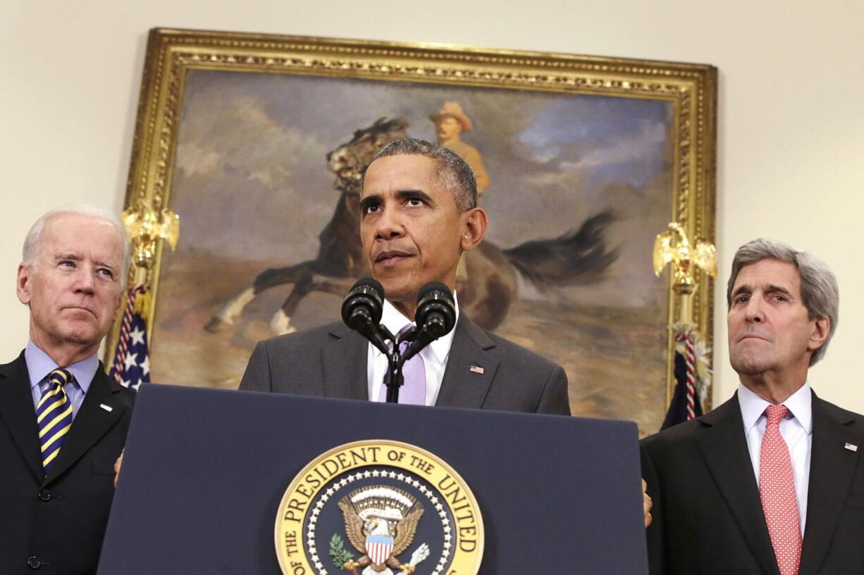 President Barack Obama, flanked by Vice President Joe Biden, left, and Secretary of State John Kerry, right, speaks about the Islamic State group in the Roosevelt Room of the White House in Washington.