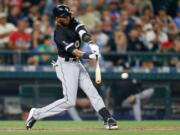 Chicago White Sox's Alexei Ramirez hits an RBI single during the ninth inning in Seattle.