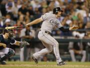 Chicago White Sox's Conor Gillaspie watches his RBI single against the Seattle Mariners during the 10th inning of a baseball game in Seattle on Saturday, Aug. 9, 2014.