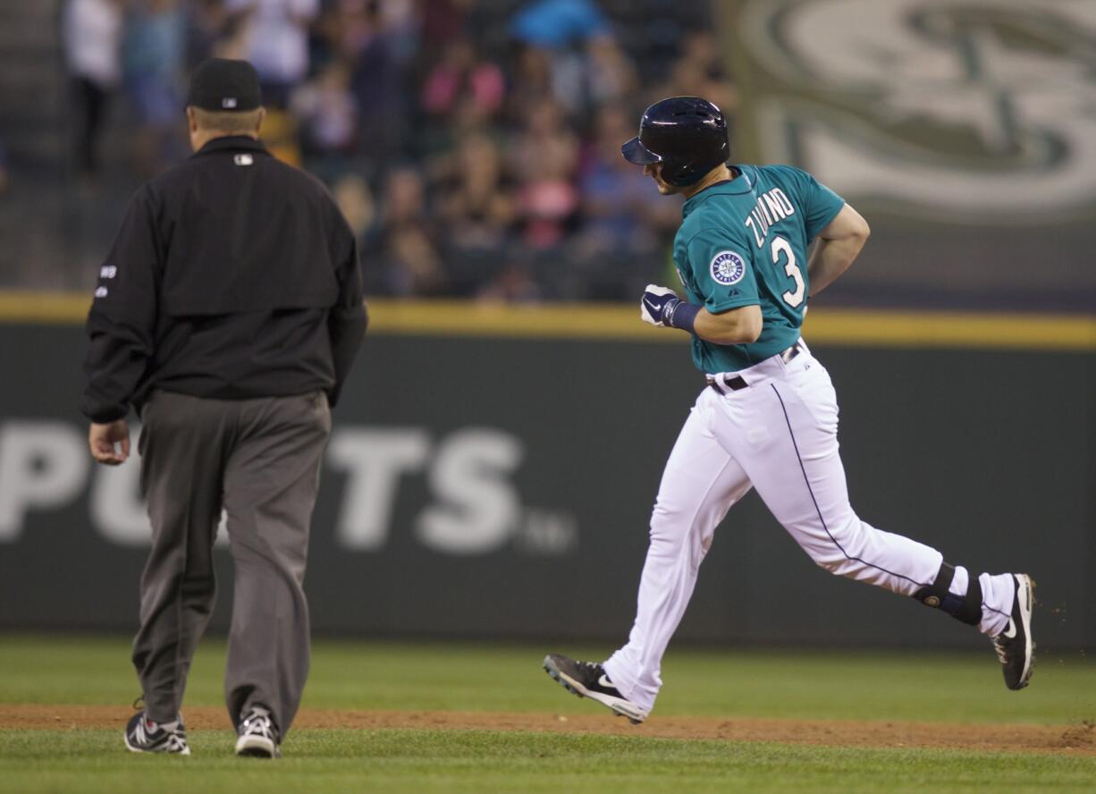 Seattle Mariners' Mike Zunino rounds the bases after hitting a three-run home run during the fifth inning of a baseball game against the Chicago White Sox, Friday, Aug. 8, 2014, in Seattle.