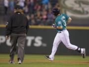 Seattle Mariners' Mike Zunino rounds the bases after hitting a three-run home run during the fifth inning of a baseball game against the Chicago White Sox, Friday, Aug. 8, 2014, in Seattle.