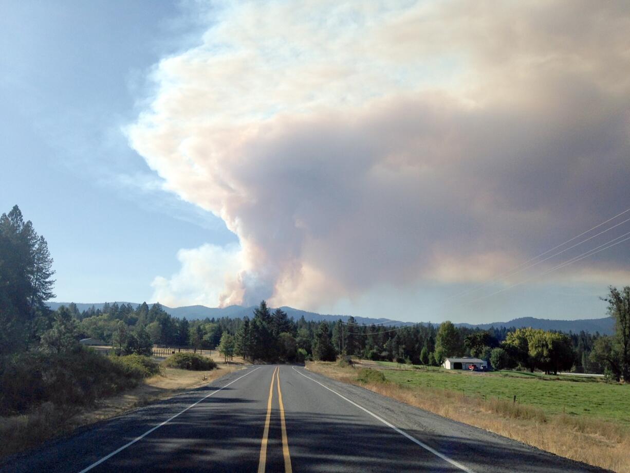 In this Sept. 14, 2014, file photo, a plume of smoke churns out of the Onion Mountain fire in the Rogue River-Siskiyou National Forest 15 miles west of Grants Pass, Ore.