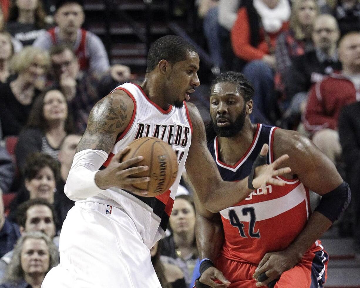 Portland Trail Blazers forward LaMarcus Aldridge, left, drives against Washington Wizards center Nene during the first half Saturday, Jan. 24, 2015.