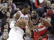 Portland Trail Blazers forward LaMarcus Aldridge, left, drives against Washington Wizards center Nene during the first half Saturday, Jan. 24, 2015.