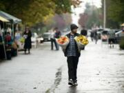 Jason Goff of Vancouver's Hudson's Bay neighborhood bought flowers at the Vancouver Farmers Market on Sunday to give as gifts to visiting family members.