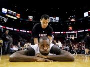 Miami Heat's LeBron James stretches before Thursday's game against the Portland Trail Blazers at the Rose Garden.