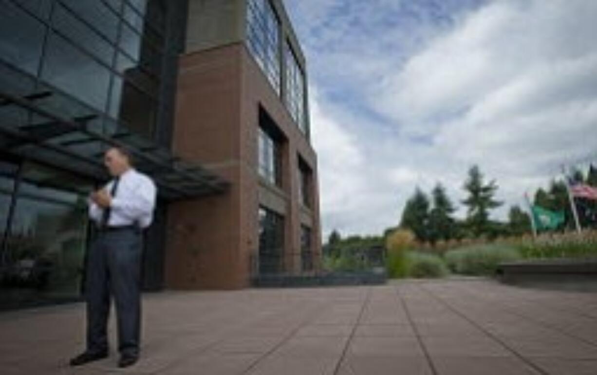 Tim Haldeman, facilities, risk and property services director for the city of Vancouver, leads a tour of Vancouver's new City Hall building, which once housed The Columbian, in August.