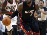 Miami Heat's LeBron James (6) brings the ball up as Portland Trail Blazers' Gerald Wallace follows during the second quarter Thursday.