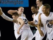 Union celebrates after beating Jackson in overtime at the Class 4A State Basketball Tournament in Tacoma on  Thursday.