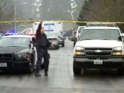 A Vancouver police officer provides assistance during an investigation of a fatal shooting at 14802 N.E. 33rd St. on Jan.