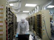 An nLight employee monitors temperature while running a test inside the Test Department in August 2011. Some Portland-Vancouver area employers say they have more manufacturing jobs than workers ready and willing to build their products.