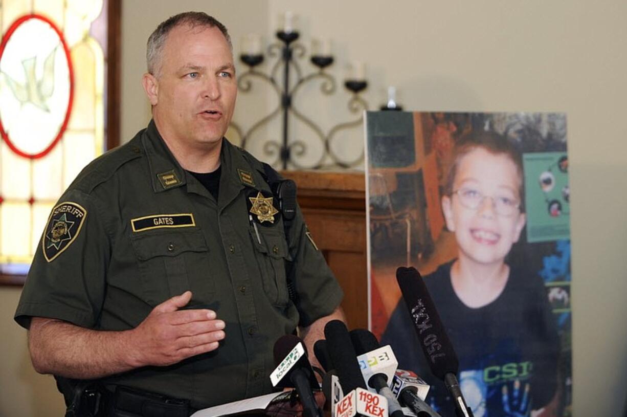 Capt. Jason Gates of the Multnomah County Sheriff's office talks to reporters as he stands next to a photo of missing 7-year-old Kyron Horman, at a church across from Skyline Elementary School in Portland, Ore., Monday.