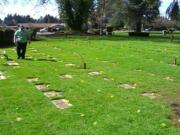 Teresa Wentworth, her two teenagers and a friend, decorated the graves in the Baby Heaven section of Evergreen Memorial Gardens Cemetery with fresh-cut daffodils.