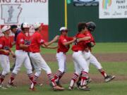 Hazel Dell Metro teammates congratulate Jasper Rank after his walk-off single scored Sam Lauderdale in Friday's 3-2 win over White Hall, Ark., in the Babe Ruth 14-Year-Old World Series.