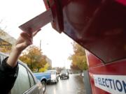 Voters use a drive-up collection box to cast their ballots in November 2013 near the Clark County elections office, 1408 Franklin St., in downtown Vancouver. They have until 8 p.m. today to drop their ballots in one of the drop boxes located throughout the county.