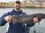 Ethan Crawford of Moscow, Idaho, hold a 9.4-pound coho taken in the state's first coho season.