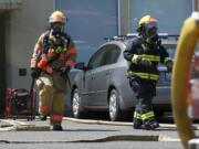 Firefighters battle a small fire Tuesday, July 15, 2014 at the Town Plaza in Vancouver, the former Tower Mall. The fire was reported around 1:30 p.m. at 5411 E. Mill Plain Blvd., which houses social services.