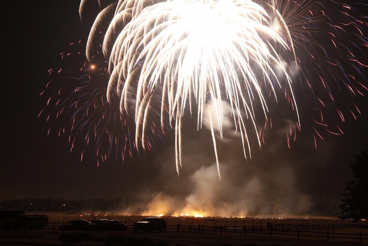 A field burns below the annual fireworks display Saturday at Fort Vancouver.