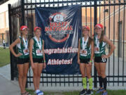 Members of the Evergreen Storm Track Club 4x800 meter relay pose by a banner at the USATF National Junior Olympic Championships on Wednesday in Houston. The team placed third among girls ages 13-14.