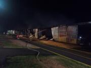 A firefighter works to extinguish hot spots in the E Hanger at Grove Field in Camas Monday evening.