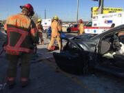 Rescue crews work at the scene of a five-vehicle injury crash in the northbound lanes of Interstate 5 near Victory Boulevard in Portland on Saturday.