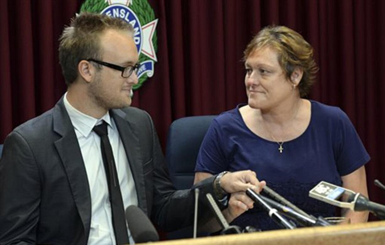 Kaylene Mann, right, and Jayden Burrows hold hands March 25 as they read a statement to the media in Brisbane, Australia, about the loss of Rod Burrows, who is Kaylene's brother and Jayden's father. Rod Burrows was among six Australians killed when Malaysia Airlines flight MH370 crashed into the Southern Indian ocean. On Friday, Mann found out that her stepdaughter, Maree Rizk, was killed along with 298 others on Malaysia Airlines Flight 17, which U.S.