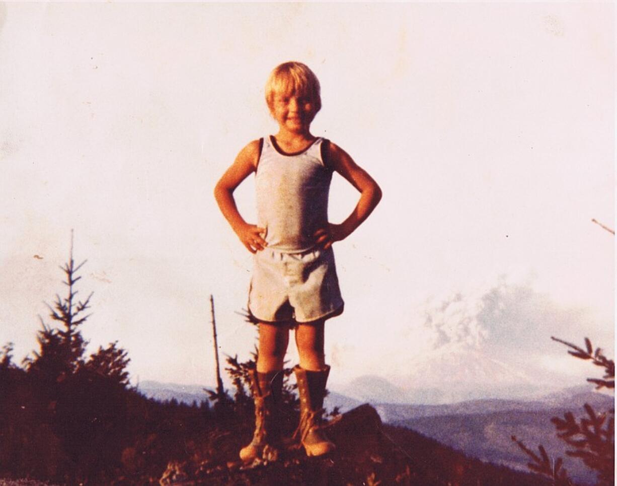 Bobby Thompson, then 5, poses for a photo as Mount St.