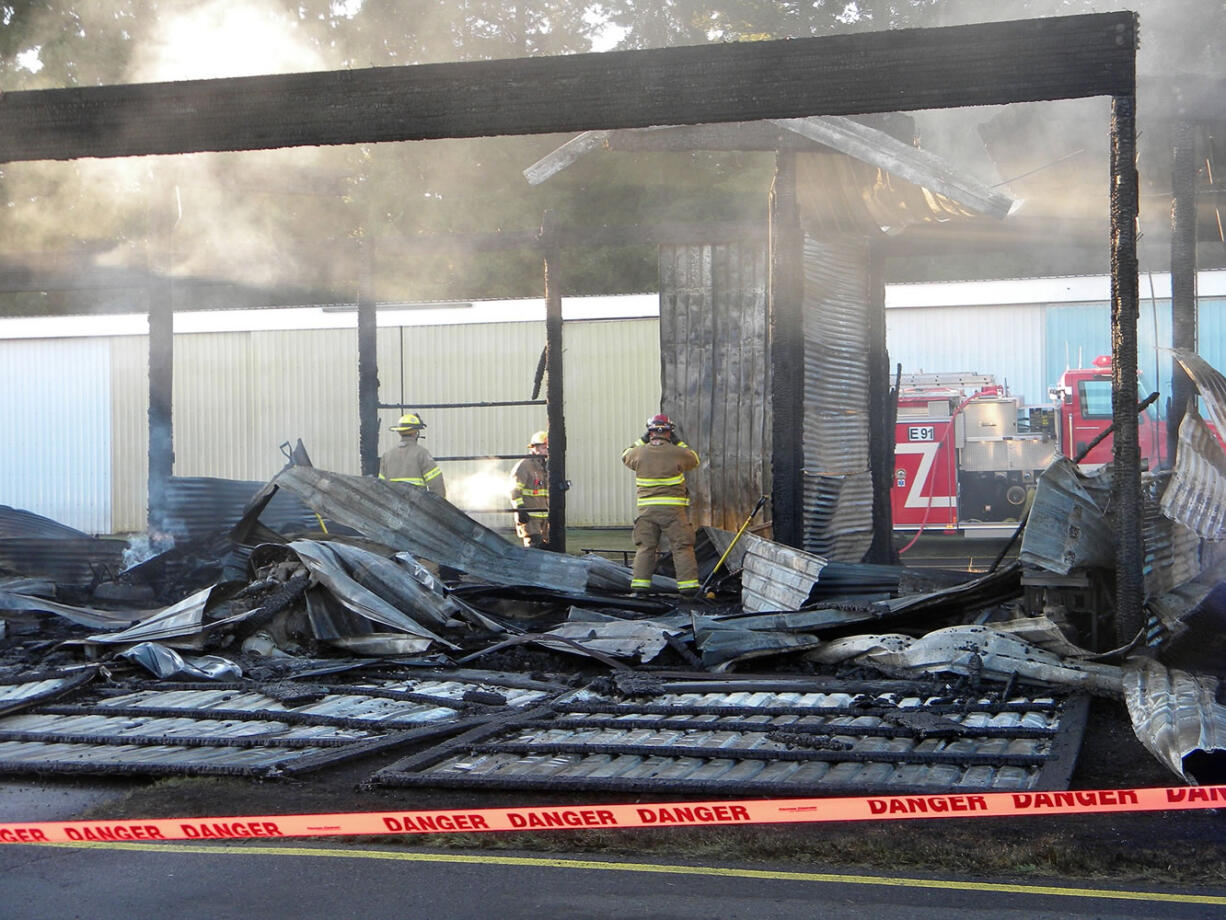 Firefighters continued overhaul Tuesday morning after a late night fire ripped through a large hangar at Grove Field in Camas Monday.