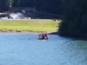 Emergency crews respond to the Lewis River south of Woodland, where a teenage boy presumably drowned Sunday after trying to swim across the river with his friends.