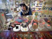 Yan Chiu, owner of Sunny Market on Northeast Minnehaha Street in Vancouver, shows a selection of glass smoking pipes that are labeled for tobacco use only.