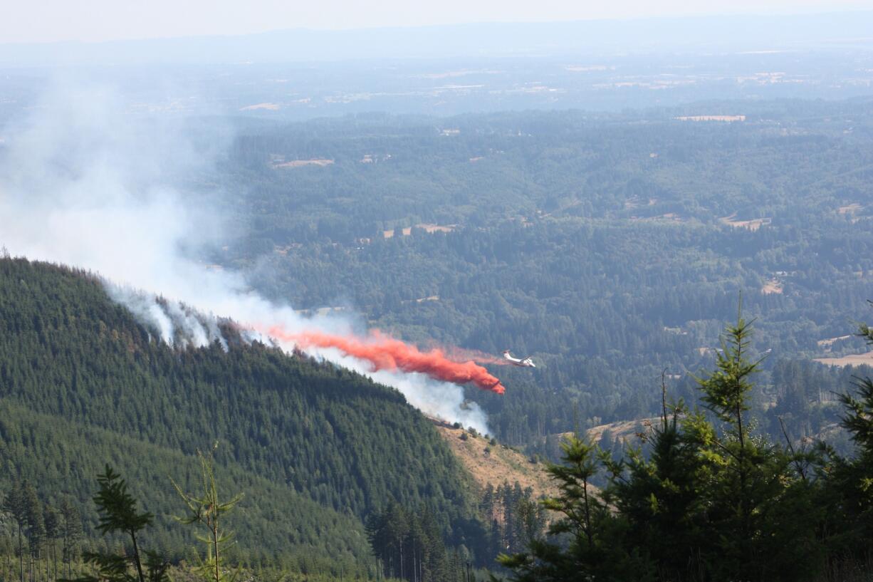 A tanker drops fire retardant on Colvis Creek Fire, as seen from Davis Peak Road, about 7 p.m.