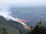 A tanker drops fire retardant on Colvis Creek Fire, as seen from Davis Peak Road, about 7 p.m.