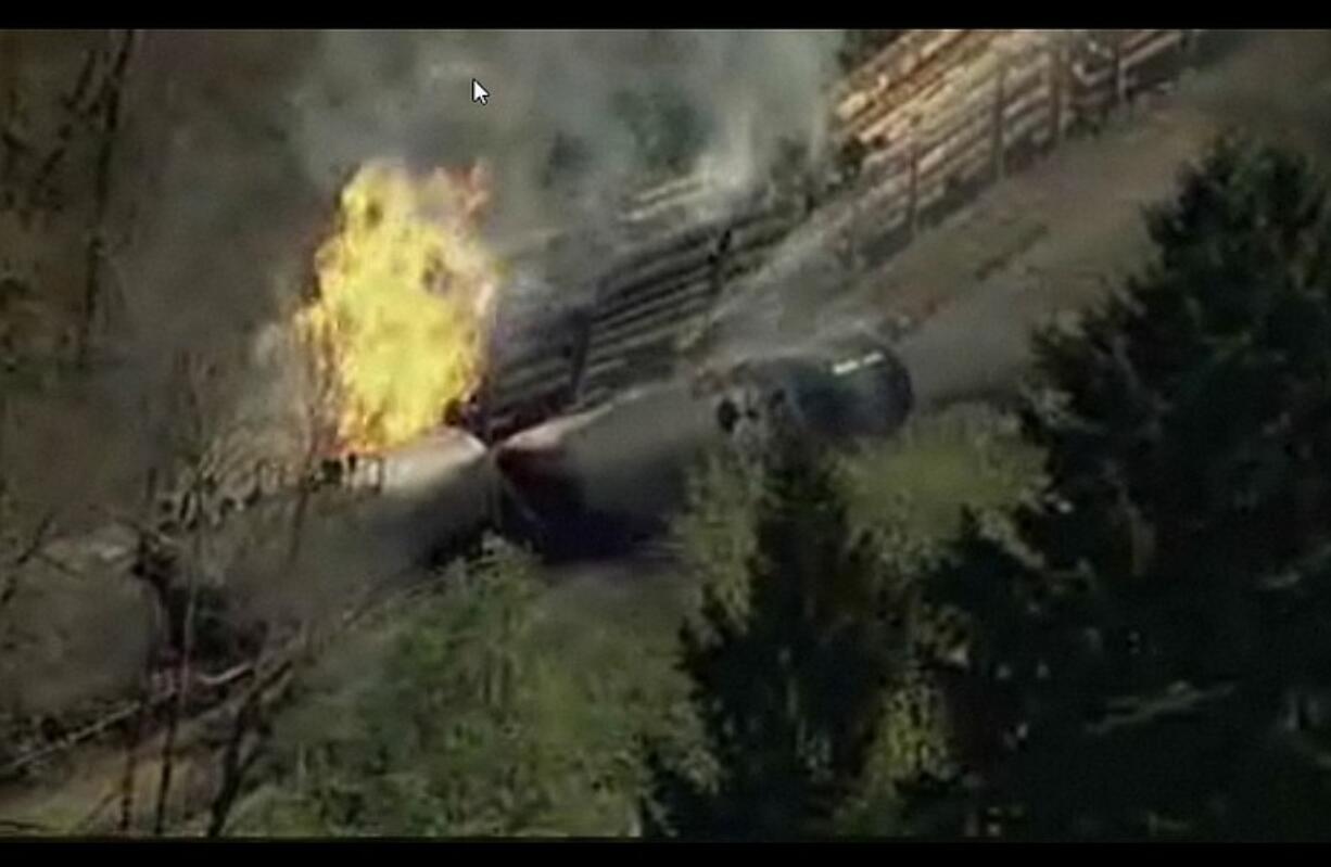 Tank cars containing ethanol burn after a derailment at about milepost 13 on state Highway 30 north of Cornelius Pass Road near Scapoose, Ore.