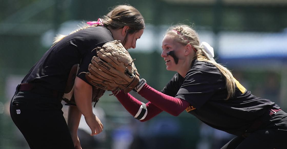 Prairie center fielder Jamie Phares (right) comforts left fielder Tristan St. Peter after St. Peter made the final out of the sixth inning against Kelso. The fly ball initially popped out of St. Peter's glove, but the junior quickly recovered to grab the ball out of the air before it hit the ground, leading to an anxious moment for St. Peter and the Falcons.