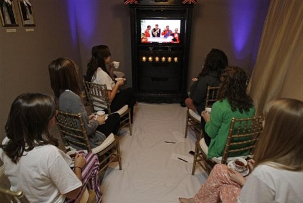 A group of close friends watch in indianapolis, Friday, April 29, 2011, as guests arrive for the wedding of Britain's Prince William and Kate Middleton.