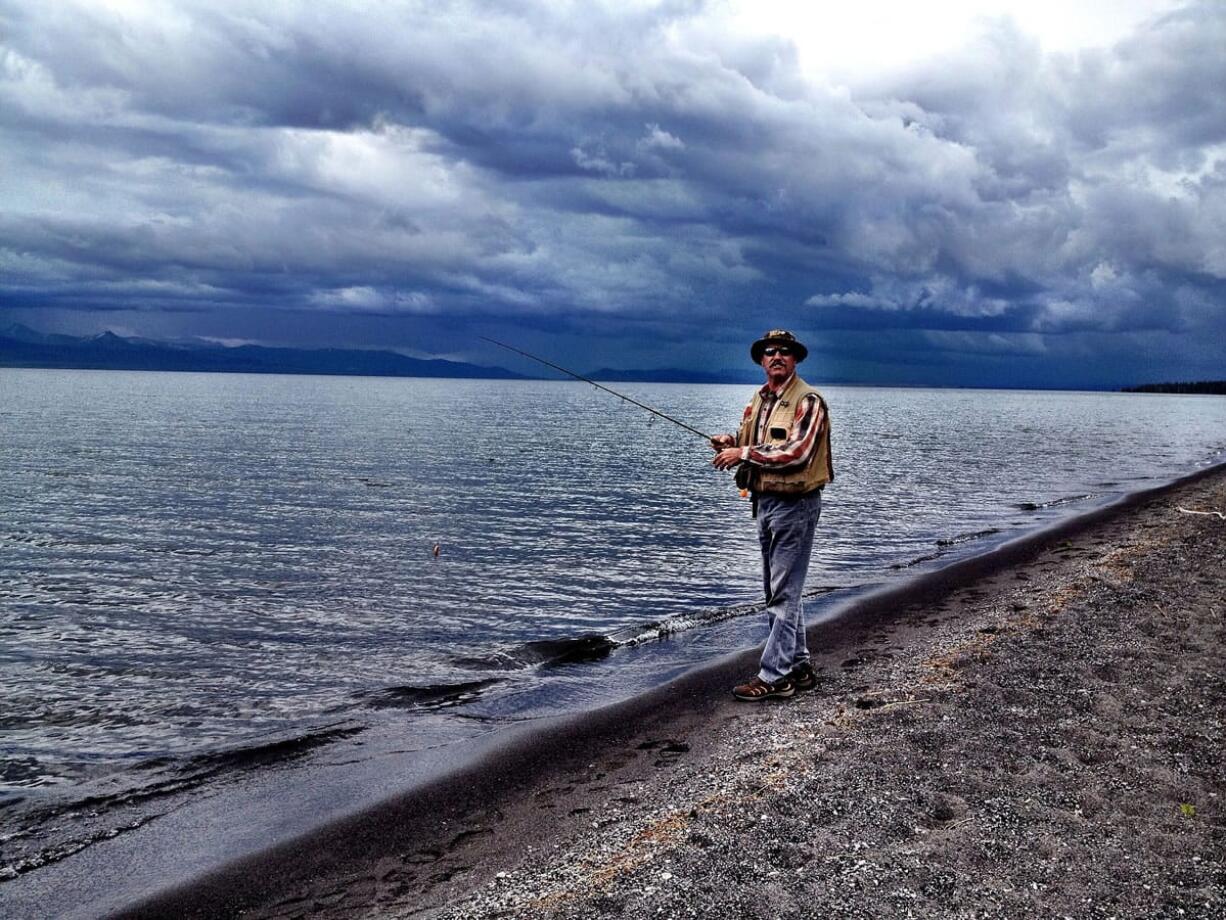 Mike Cox of California tries his luck fishing at Yellowstone Lake.