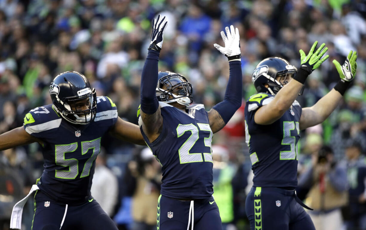 Seattle Seahawks strong safety Jeron Johnson (23) celebrates his tackle of San Francisco 49ers wide receiver Bruce Ellington (not shown) in the second half Sunday, Dec.