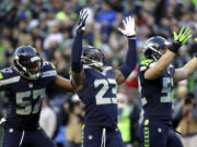 Seattle Seahawks strong safety Jeron Johnson (23) celebrates his tackle of San Francisco 49ers wide receiver Bruce Ellington (not shown) in the second half Sunday, Dec.