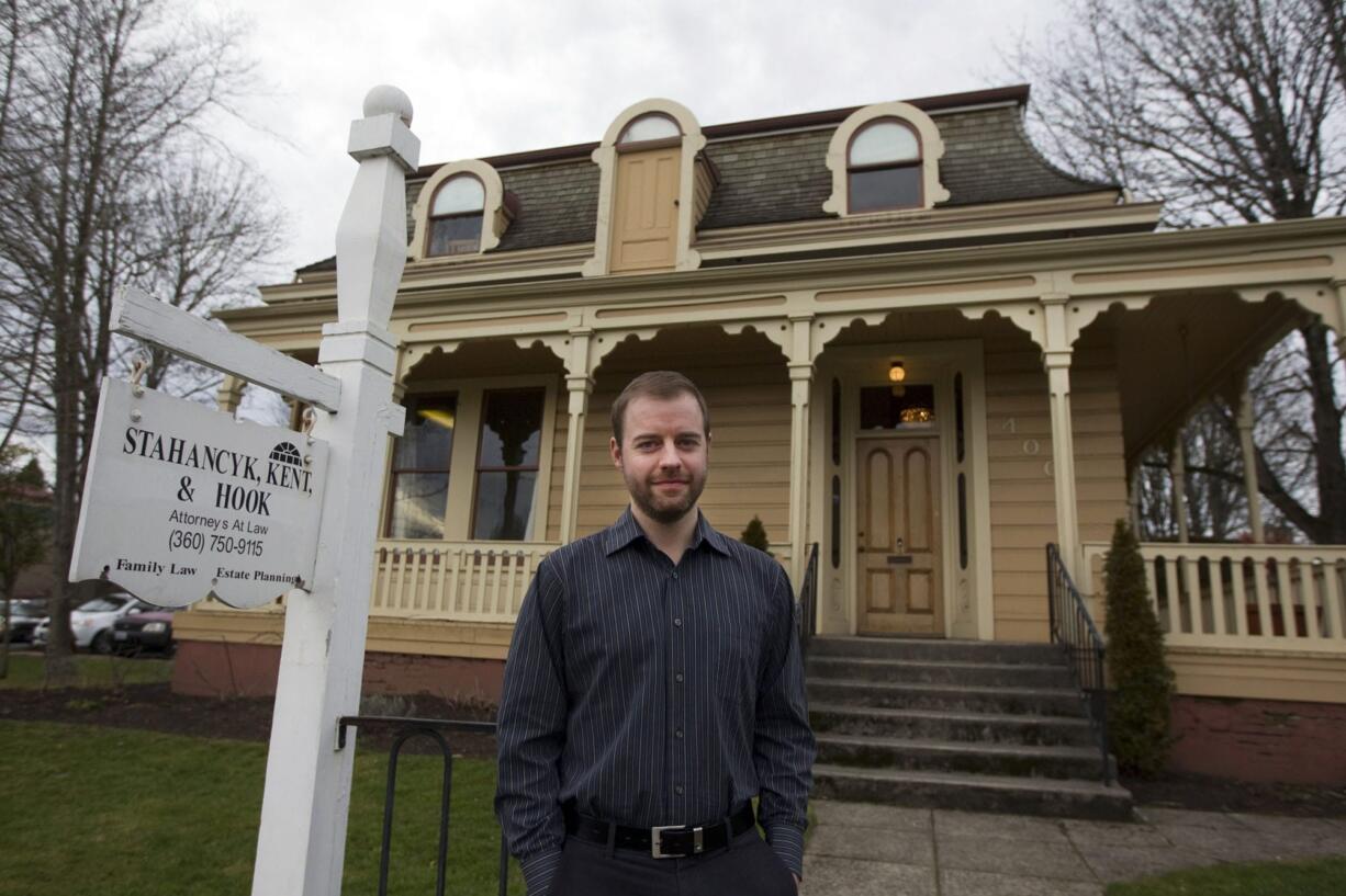 Vince Roman stands outside the Charles Brown House, built in 1866 and now the downtown Vancouver law office of Stahancyk, Kent &amp; Hook.