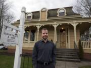 Vince Roman stands outside the Charles Brown House, built in 1866 and now the downtown Vancouver law office of Stahancyk, Kent &amp; Hook.