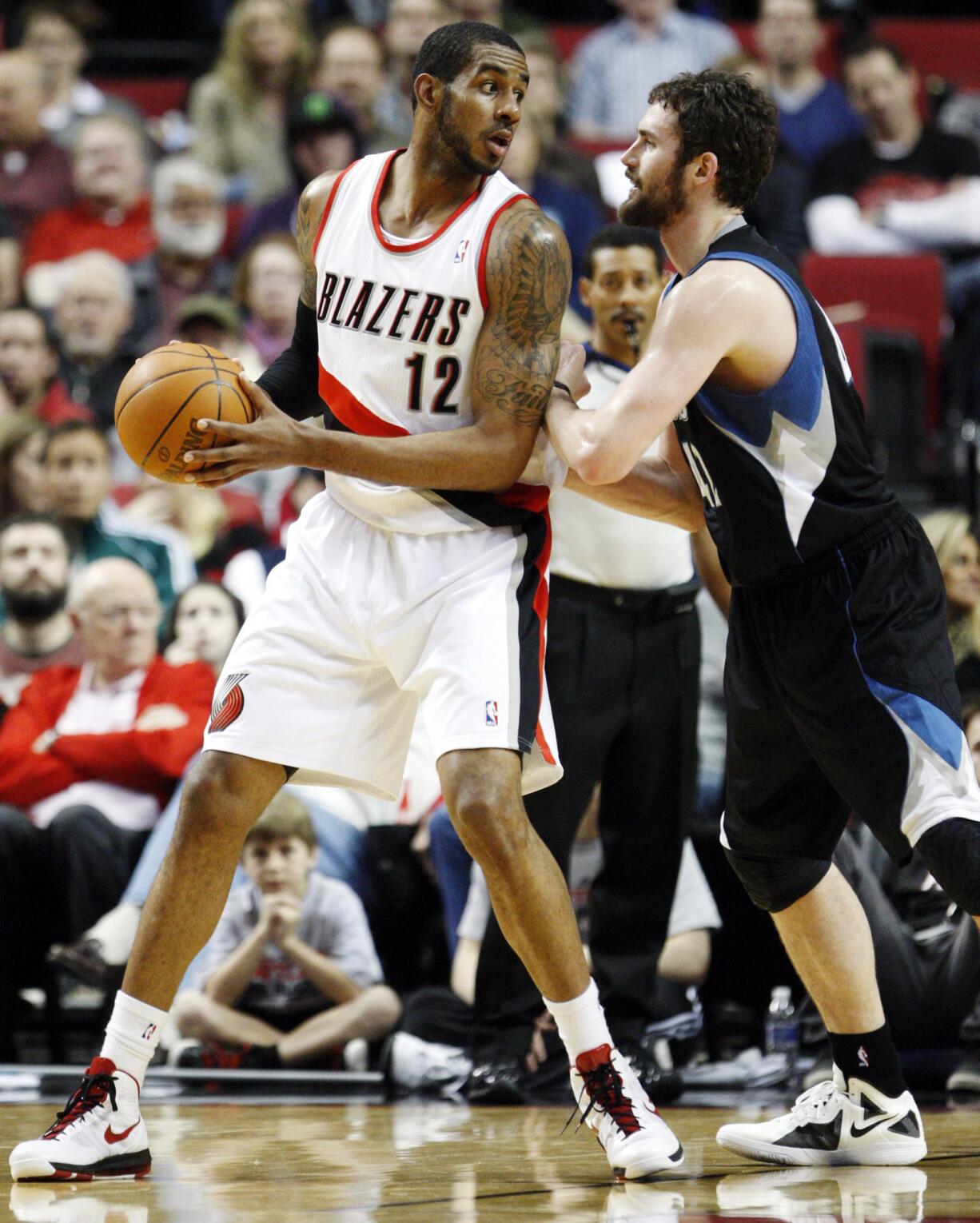 Minnesota Timberwolves' Kevin Love, right, defends against Portland Trail Blazers' LaMarcus Aldridge (12) during a game in 2012. The two faceoff again Saturday at the Moda Center.