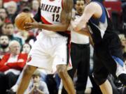 Minnesota Timberwolves' Kevin Love, right, defends against Portland Trail Blazers' LaMarcus Aldridge (12) during a game in 2012. The two faceoff again Saturday at the Moda Center.