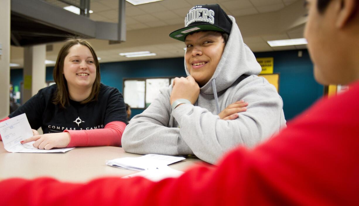 Western Washington University senior Alexa Tucker, left, helps Julian Gonzalez, center, and Gurjit Uppal study for a biology exam at Squalicum High School in Bellingham on Jan.