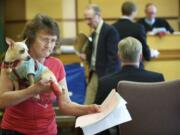 Hazel Trent of Vancouver leaves a Clark County courtroom May 14 with her service dog, Max.