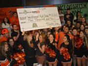 An enthusiastic group of WHS students accepted a $10,000 check in the Cash for Schools contest.