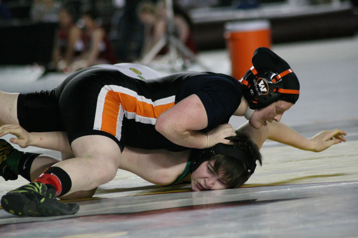 Washougal freshman Abby Lees drills Tumwater's Megan Johnson's face in the mat during the first round of the girls 155-pound state championship match Saturday, at the Tacoma Dome.