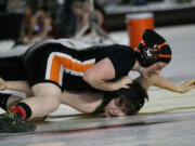 Washougal freshman Abby Lees drills Tumwater's Megan Johnson's face in the mat during the first round of the girls 155-pound state championship match Saturday, at the Tacoma Dome.