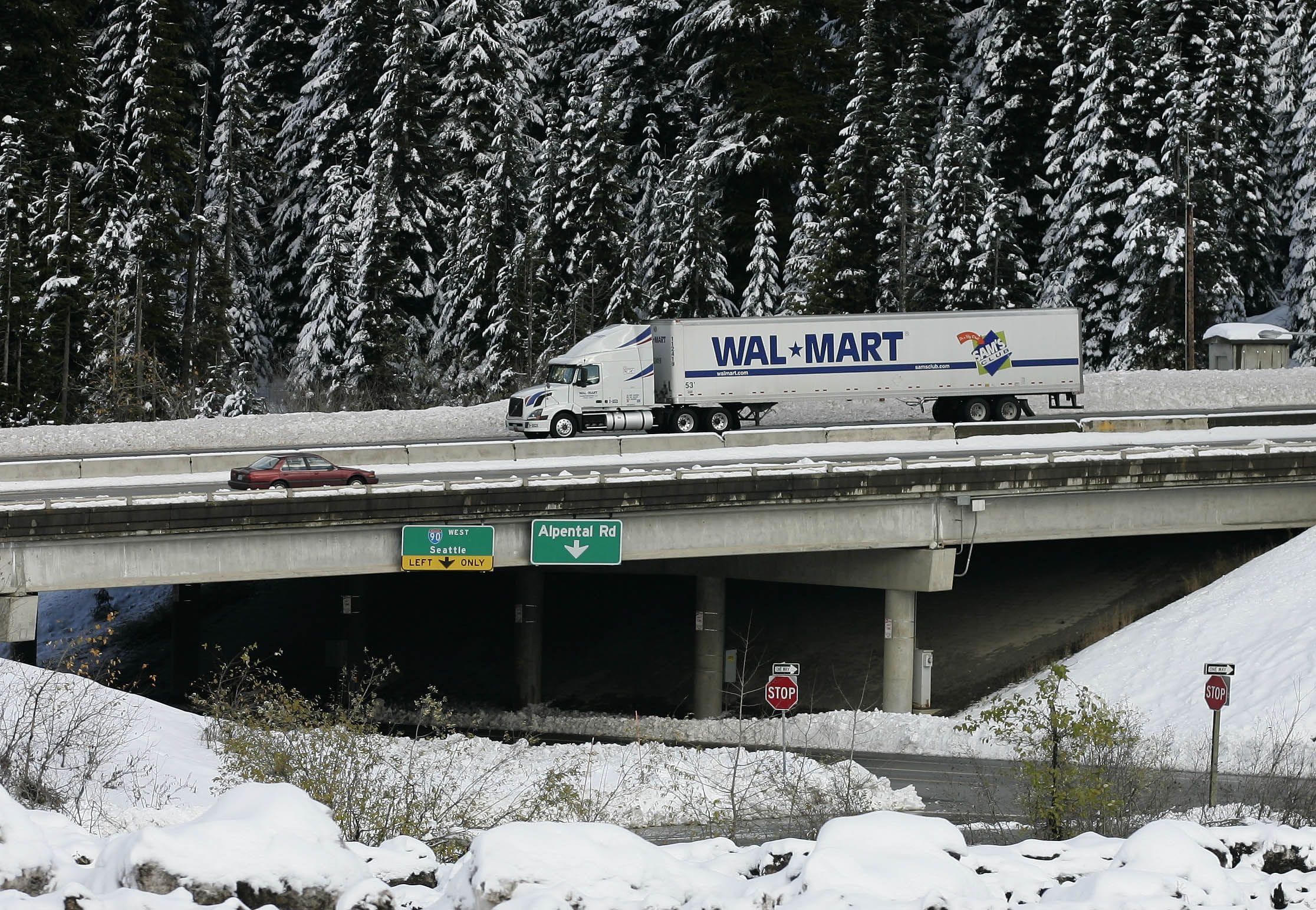 A Wal-Mart truck drives westbound through the snow on I-90 over Snoqualmie Pass near Hyak. Interstate 90 through the pass is on Gov.