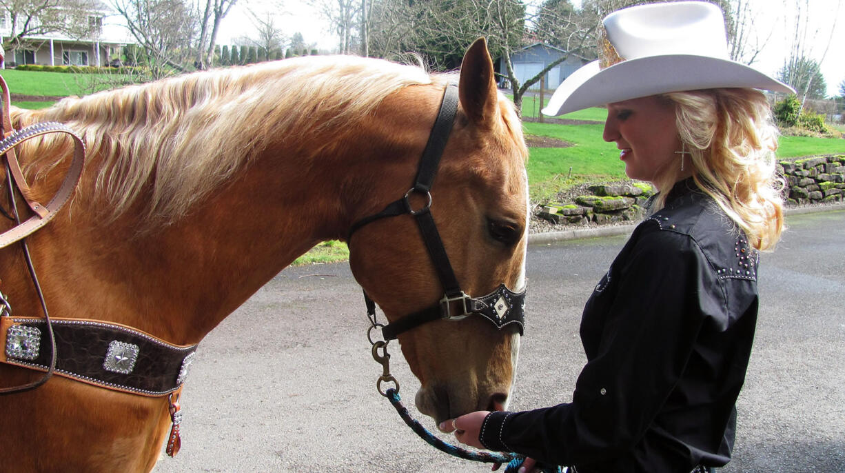 Amanda Knapp feeds grain to Carter. Knapp, 20, is the Miss Vancouver Rodeo Queen for 2014. The rodeo will be held July 2-5, at the Clark County Saddle Club.